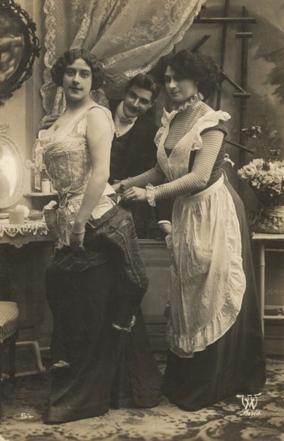 Man watching a woman dress by French Photographer